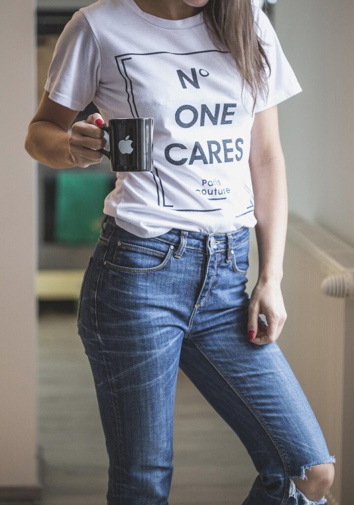 jeans, tee, t shirt, white, blue, woman, model, standing, mug, cup, coffee, tea, hot, tea cup, drink, hair, quote, statement, ripped, coffee cup, top, trousers, home, young, casual, outfit